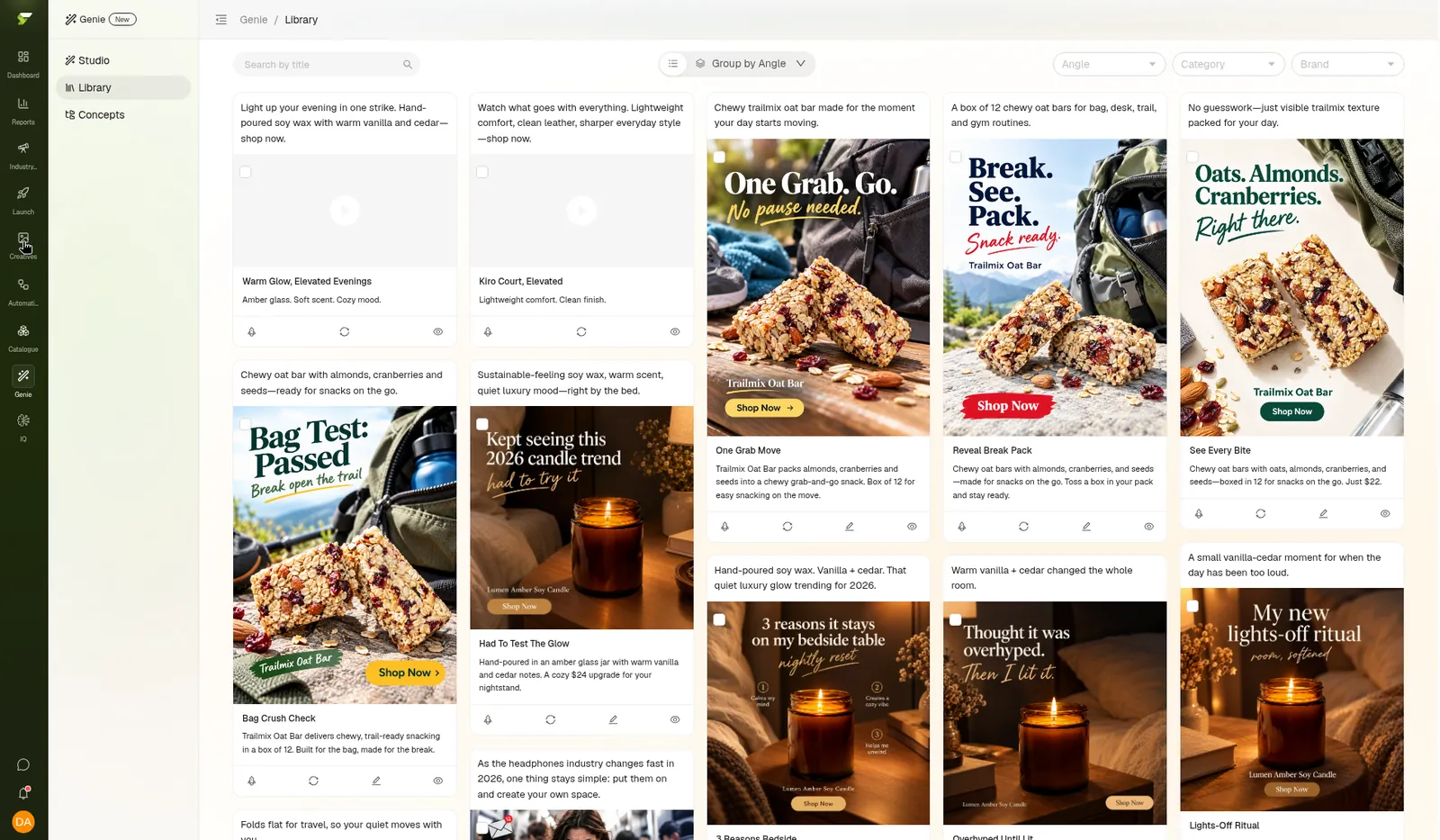 Genie Library showing generated image ads for a trail mix bar and a soy candle, grouped as variations with copy under each card